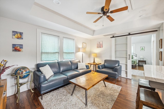 1343 Allston St, Houston, TX 77008 - living room featuring a ceiling fan, a barn door, wood finished floors, and a raised ceiling