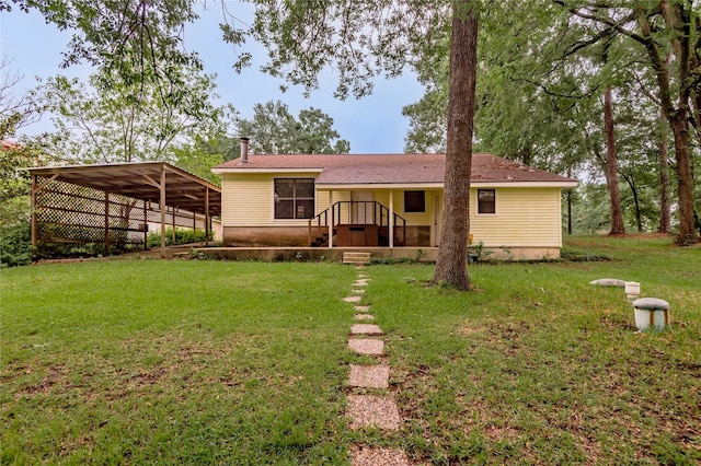 350 Shoreline Dr, Huntsville, TX 77320 - back of house featuring a lawn and a detached carport