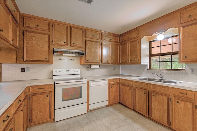 350 Shoreline Dr, Huntsville, TX 77320 - kitchen featuring brown cabinets, a sink, light countertops, white appliances, and range hood
