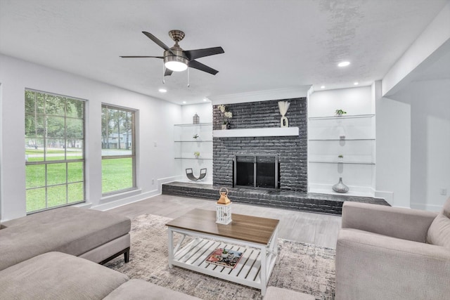 561 Brandon Rd, Conroe, TX 77302 - living area with recessed lighting, wood finished floors, ceiling fan, and a brick fireplace