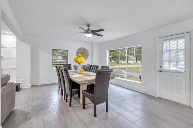 561 Brandon Rd, Conroe, TX 77302 - dining area with wood tiled floor, a healthy amount of sunlight, a ceiling fan, and baseboards