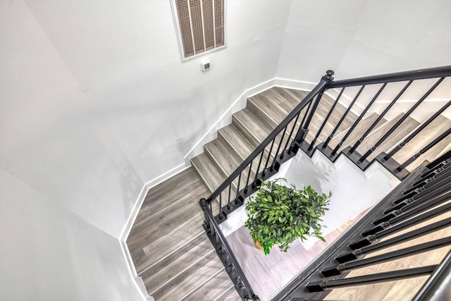 561 Brandon Rd, Conroe, TX 77302 - stairs featuring wood finished floors, visible vents, and baseboards