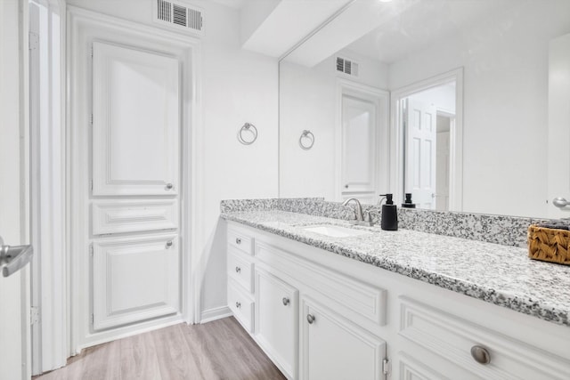 561 Brandon Rd, Conroe, TX 77302 - bathroom featuring visible vents, wood finished floors, and vanity