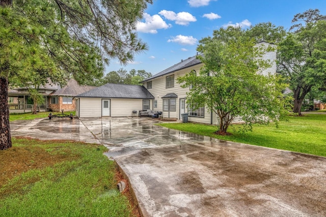 561 Brandon Rd, Conroe, TX 77302 - view of front of house featuring a patio, a chimney, driveway, and a front yard