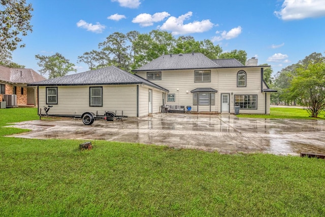561 Brandon Rd, Conroe, TX 77302 - back of house with cooling unit, a patio, a lawn, and a chimney