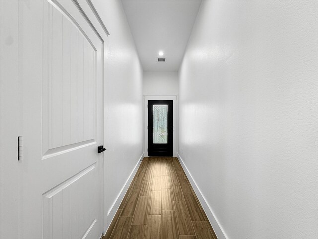 doorway to outside with baseboards, visible vents, dark wood-type flooring, and recessed lighting