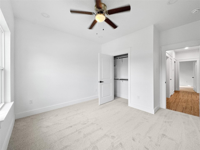 unfurnished bedroom featuring a ceiling fan, carpet flooring, a closet, and baseboards