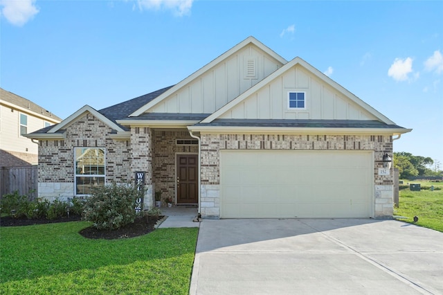 view of front facade featuring board and batten siding, stone siding, a front yard, concrete driveway, and an attached garage