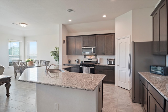 kitchen featuring a sink, stainless steel appliances, dark brown cabinetry, a toaster, and recessed lighting