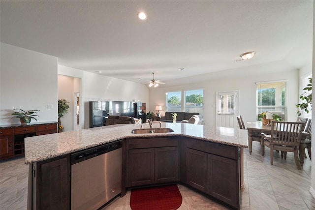kitchen featuring a wealth of natural light, open floor plan, dishwasher, and a sink