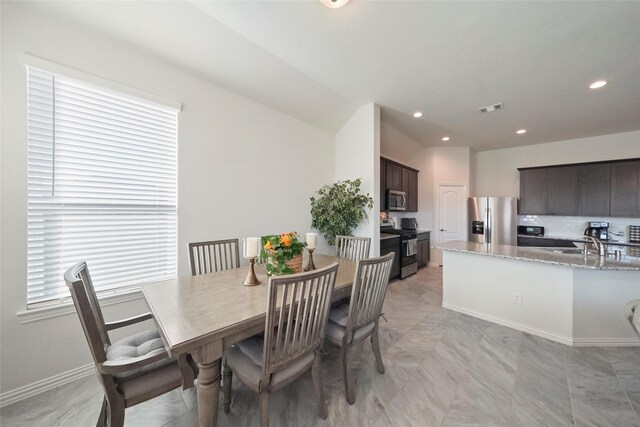 dining room featuring recessed lighting, visible vents, lofted ceiling, and baseboards