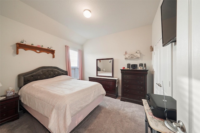 bedroom with vaulted ceiling and carpet floors