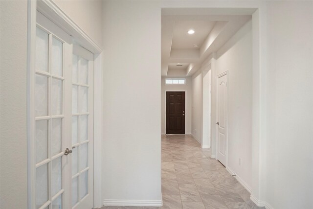 152 Bayou Bend Blvd, Angleton, TX 77515 - hallway featuring french doors, light marble finish flooring, a tray ceiling, and recessed lighting