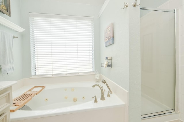 full bath with a tub with jets, a stall shower, and vanity