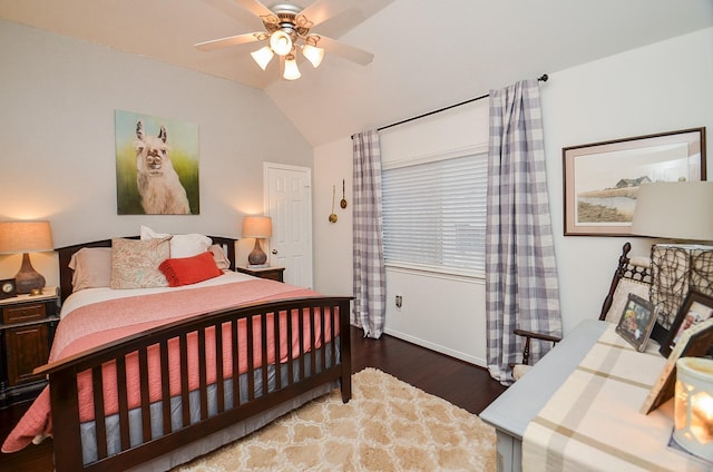 bedroom featuring baseboards, wood finished floors, a ceiling fan, and vaulted ceiling