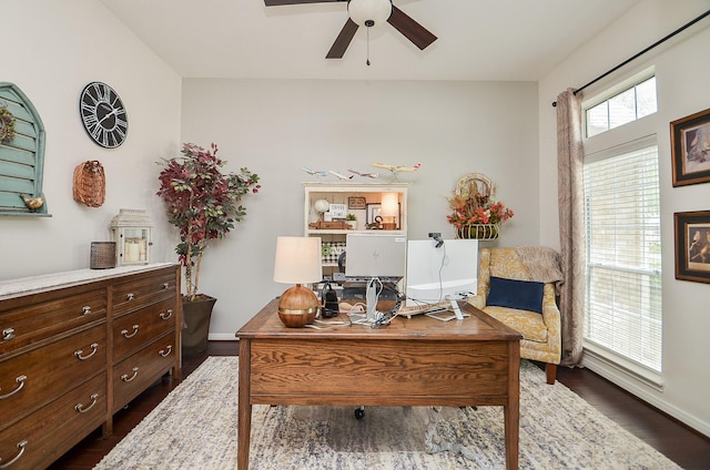 office area with dark wood-style floors, baseboards, and a ceiling fan