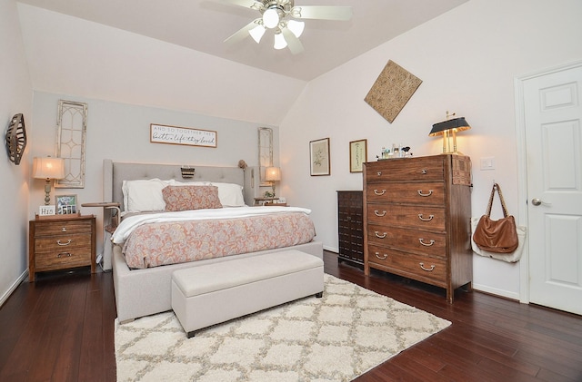 bedroom featuring lofted ceiling, baseboards, and wood-type flooring