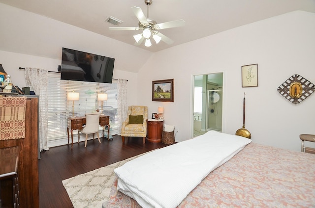 bedroom featuring dark wood-style floors, visible vents, vaulted ceiling, and connected bathroom