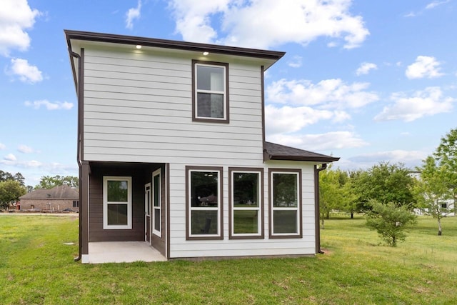 12975 Corona Ct, Willis, TX 77318 - back of house featuring a lawn and a patio area