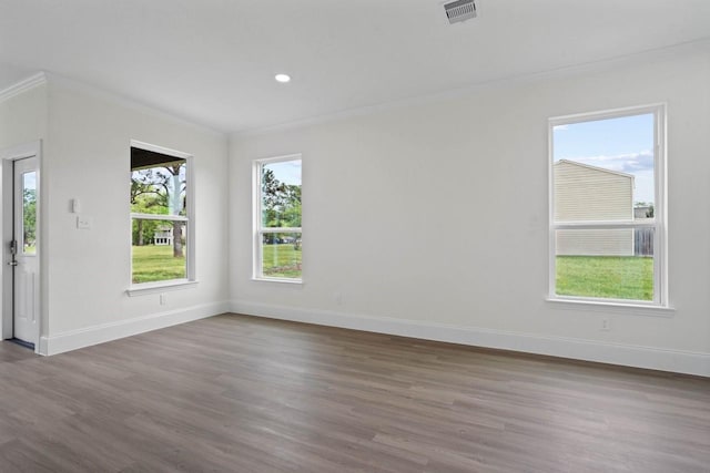 12975 Corona Ct, Willis, TX 77318 - empty room featuring visible vents, wood finished floors, baseboards, ornamental molding, and recessed lighting