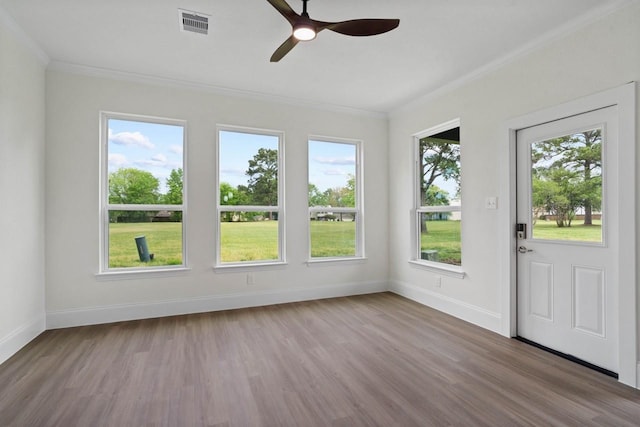 12975 Corona Ct, Willis, TX 77318 - unfurnished sunroom with baseboards, ornamental molding, wood finished floors, and visible vents