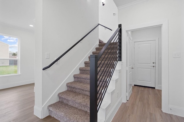 12975 Corona Ct, Willis, TX 77318 - stairs with crown molding, baseboards, and wood finished floors