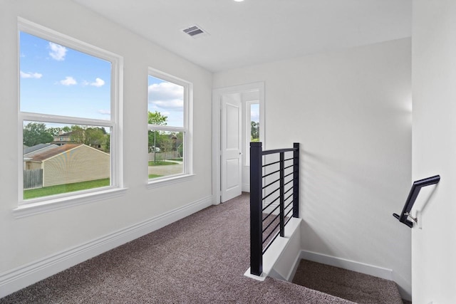 12975 Corona Ct, Willis, TX 77318 - stairs featuring carpet floors, baseboards, and visible vents