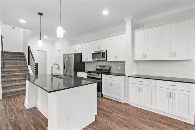 12975 Corona Ct, Willis, TX 77318 - kitchen featuring a sink, ornamental molding, dark countertops, and stainless steel appliances