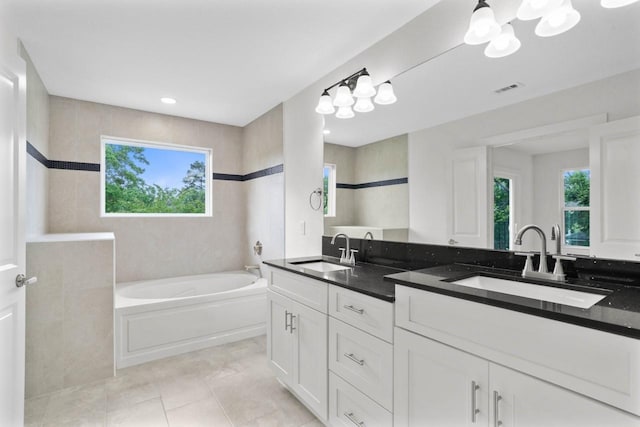 12975 Corona Ct, Willis, TX 77318 - full bathroom with a garden tub, a sink, tile patterned floors, and visible vents