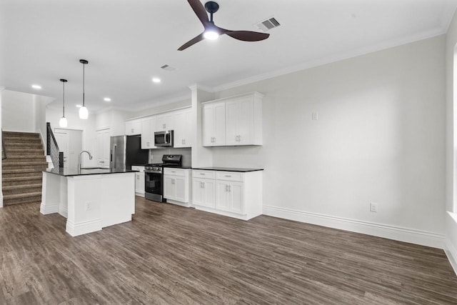 12975 Corona Ct, Willis, TX 77318 - kitchen featuring a ceiling fan, dark countertops, appliances with stainless steel finishes, and baseboards