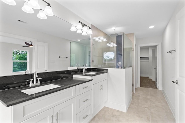 12975 Corona Ct, Willis, TX 77318 - full bath featuring visible vents, a sink, a walk in shower, and tile patterned floors