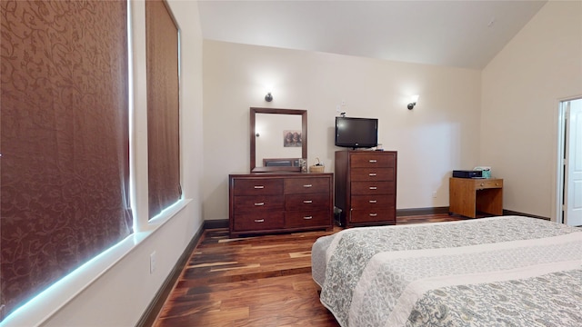 bedroom featuring dark wood-style flooring, lofted ceiling, and baseboards