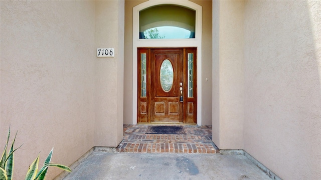 doorway to property with stucco siding