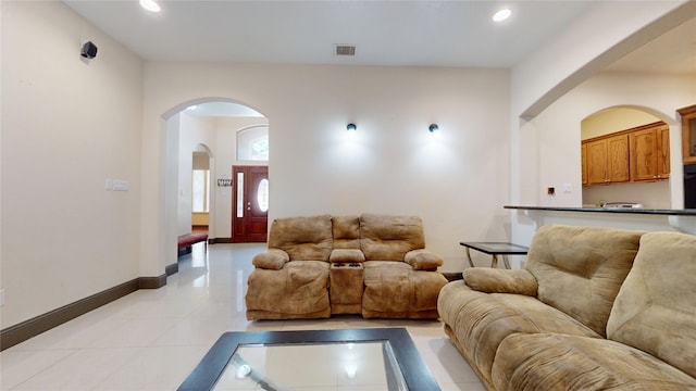 living area with visible vents, recessed lighting, baseboards, and arched walkways