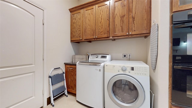clothes washing area with cabinet space and independent washer and dryer