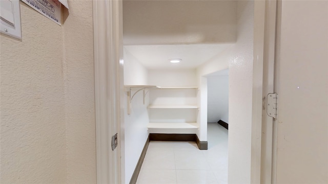 spacious closet featuring light tile patterned flooring