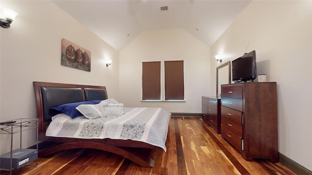 bedroom featuring visible vents, dark wood-style flooring, lofted ceiling, and baseboards