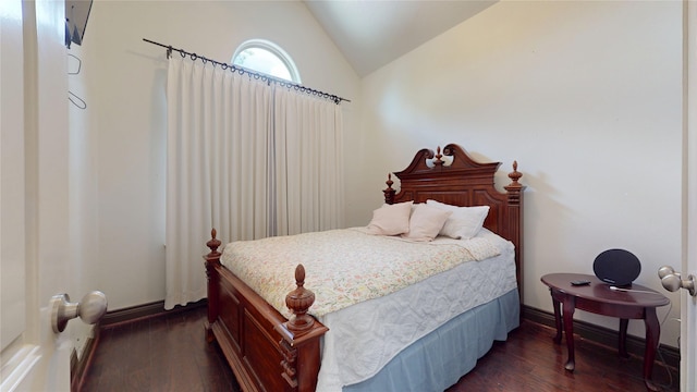 bedroom with dark wood-style floors and vaulted ceiling