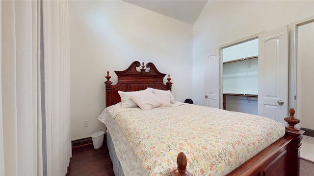 bedroom with dark wood finished floors and baseboards