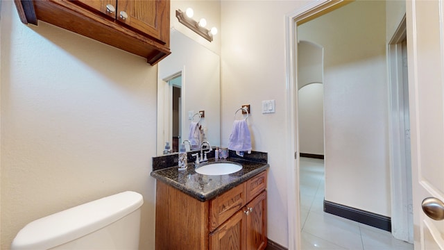 bathroom featuring tile patterned floors, vanity, and toilet