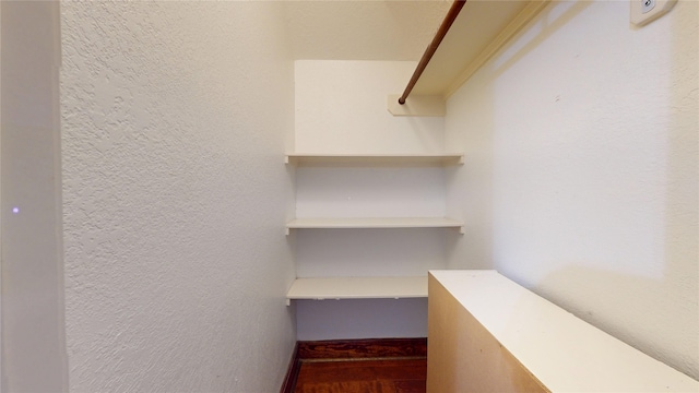 walk in closet with wood finished floors