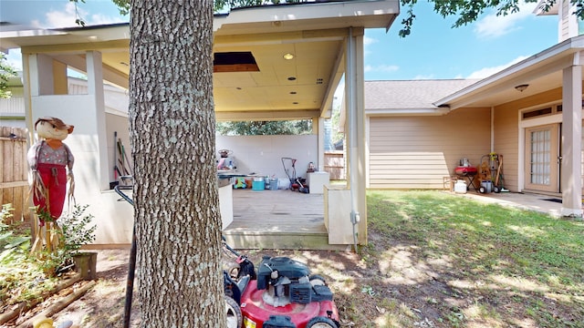 view of patio featuring a wooden deck and fence