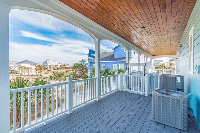 4110 Defender Ln, Galveston, TX 77554 - wooden terrace with central AC unit and a residential view