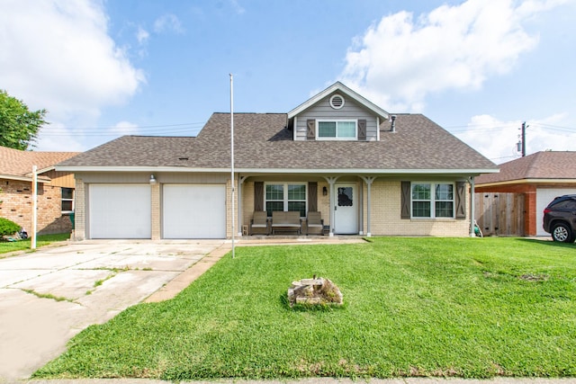 view of front of house with a front lawn, driveway, brick siding, an attached garage, and fence