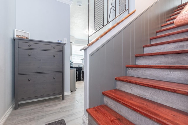 stairway featuring wood finished floors and baseboards
