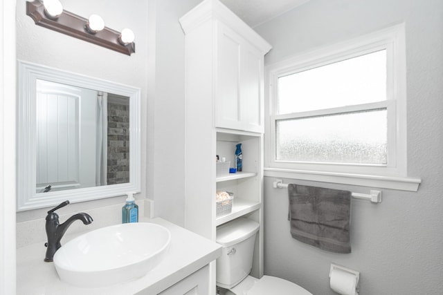 bathroom featuring toilet and vanity