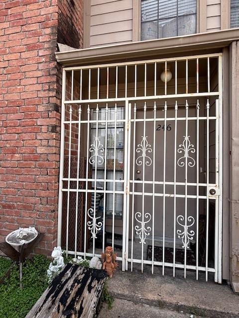 10501 S Dr Unit 246, Houston, TX 77099 - view of exterior entry with a gate and brick siding