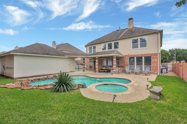 4526 Ambrosia Springs Ln, Katy, TX 77494 - back of property with an in-ground hot tub, brick siding, a patio, and a chimney