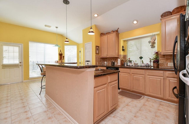 kitchen with light tile patterned floors, a breakfast bar area, light brown cabinets, vaulted ceiling, and backsplash
