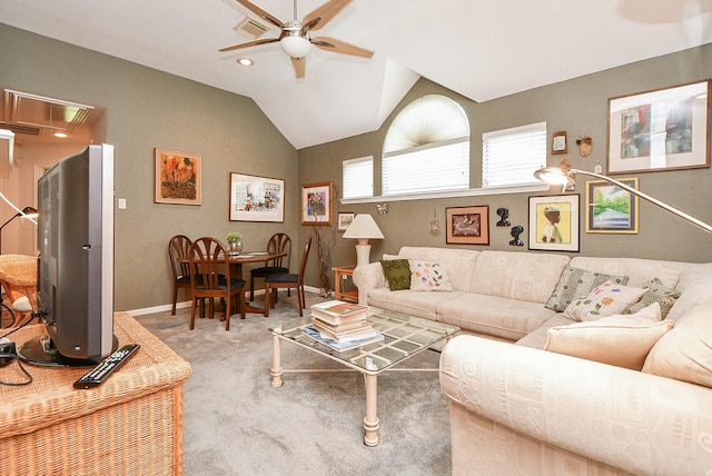 carpeted living room with visible vents, baseboards, attic access, vaulted ceiling, and a ceiling fan